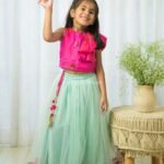 Hot pink ruffled top and green Net Lehenga set
